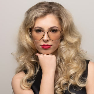 Model wearing gold frame sunglasses