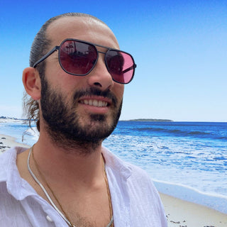 man on beach in double bridge sunglasses