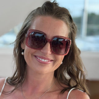 woman wearing large pink sunglasses