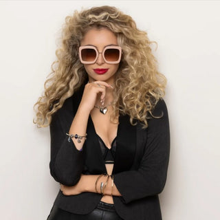 model wearing large pink sunglasses