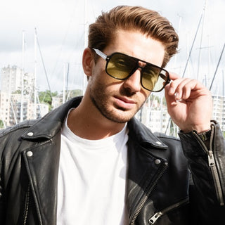 male model with black frame sunglasses with green lenses