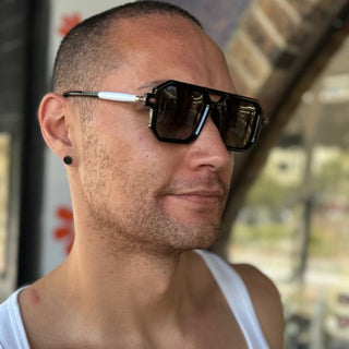 male wearing black Polaroid sunglasses with white arms