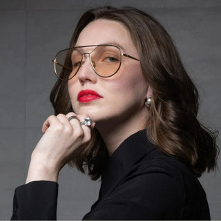woman wearing gold framed sunglasses