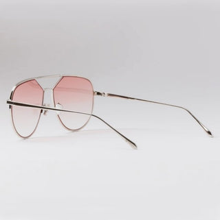 silver metal framed sunglasses with pink lenses