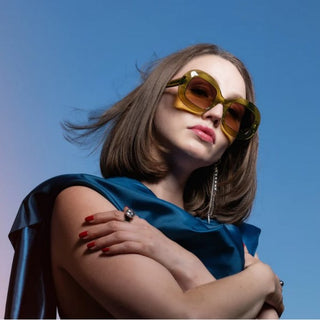 female wearing green oversized sunglasses