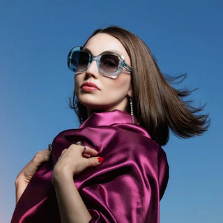 Female wearing blue oversized sunglasses
