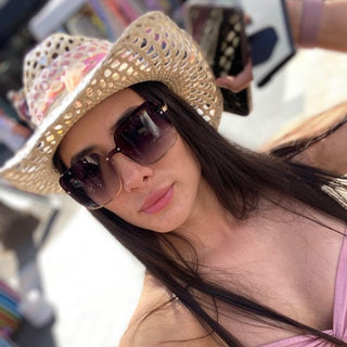 Female in cowboy hat and oversized sunglasses