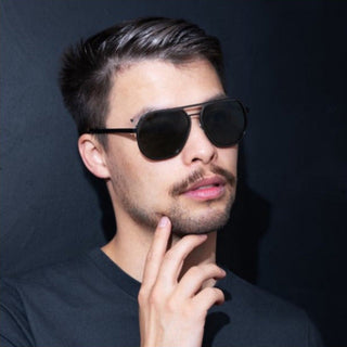 man wearing dark green aviators