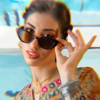 Woman wearing cat eye sunglasses with a colorful background