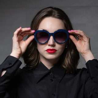 woman wearing oversized blue sunglasses