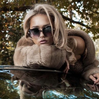female wearing oversized sunglasses and fur jacket