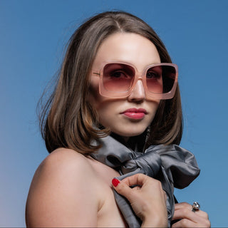 woman wearing oversized pink sunglasses