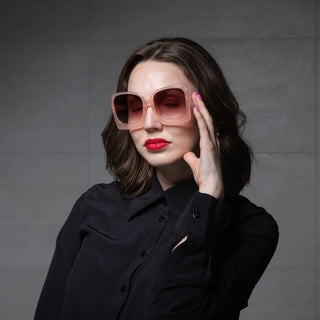 woman wearing oversized pink sunglasses