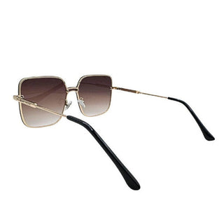 Sunglasses with gold frame and black arms on a white background