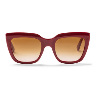 Red sunglasses with brown gradient lenses on a white background