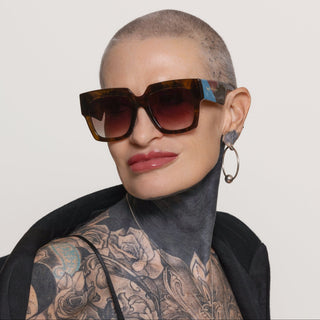 Person wearing sunglasses with a neutral background