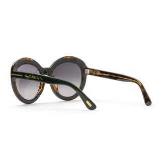 Sunglasses with tortoiseshell inner frame and dark lenses on a white background