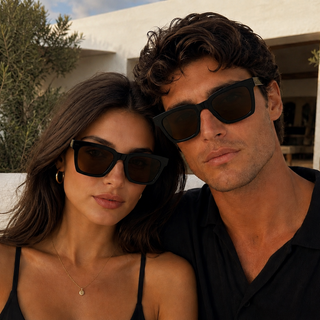 man and woman wearing black sunglasses with brown lenses