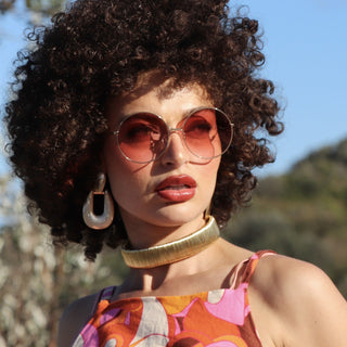 woman wearing pink lens round sunglasses