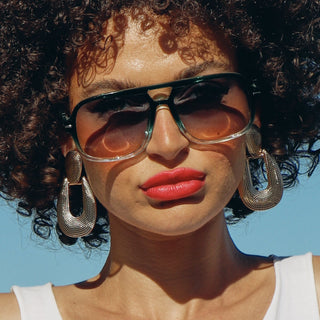 woman wearing green aviator sunglasses