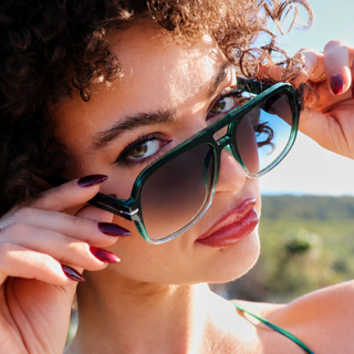woman wearing green sunglasses