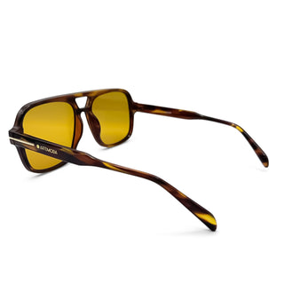Sunglasses with tortoiseshell frame and yellow lenses on a white background