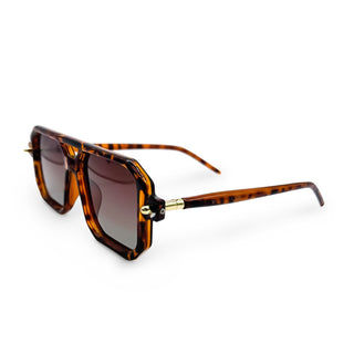 Tortoiseshell sunglasses with gold accents on a white background