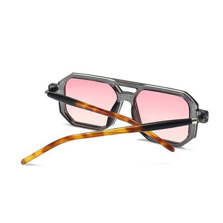 Sunglasses with pink lenses and tortoiseshell arms on a white background