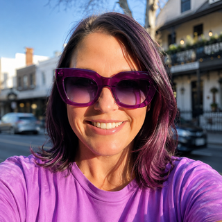 woman wearing oversized purple sunglasses