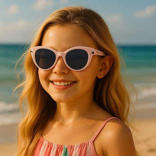 Young girl wearing sunglasses with a beach background