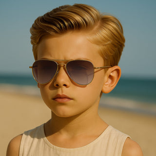 Young boy wearing sunglasses on a beach