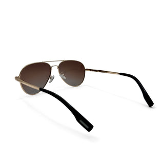 Aviator sunglasses with gold frame and black arms on a white background