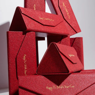 Red textured gift boxes with gold text on a white background