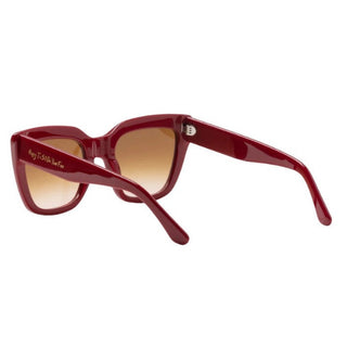 Red sunglasses with brown gradient lenses on a white background